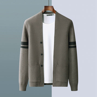 Close-up of classic buttons on a men's striped cardigan sweater, emphasizing quality & detail.