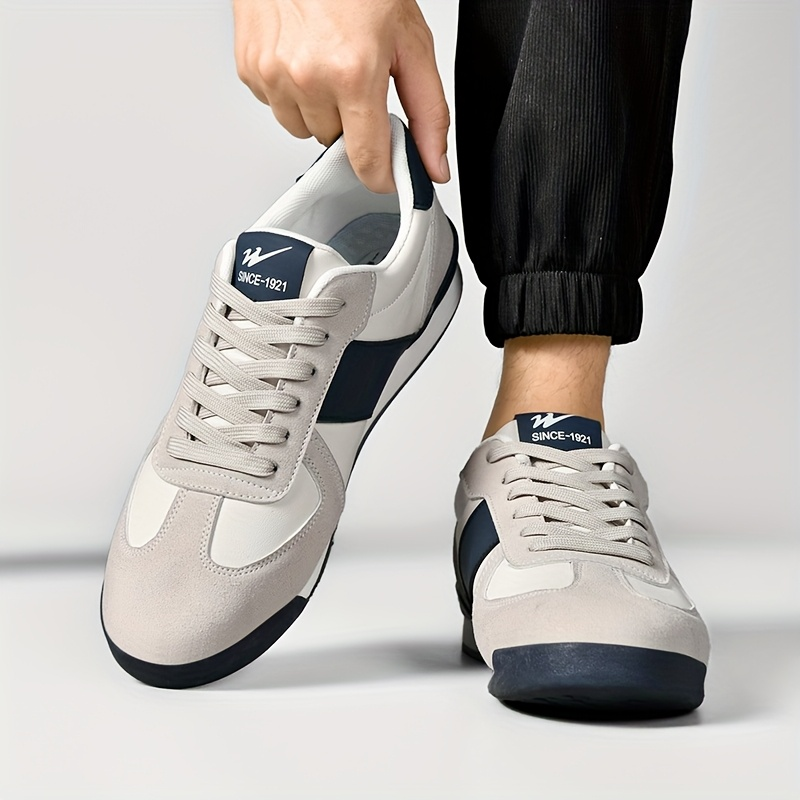 Classic retro men's striped sneakers, versatile for athletic or casual streetwear.