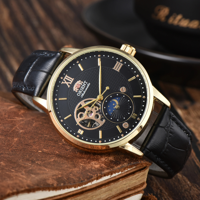 Close-up of men's classic Sun & Moon automatic watch dial, intricate details, with leather band.