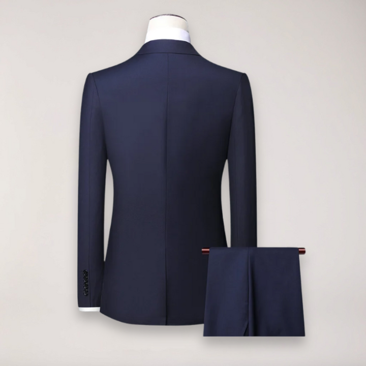 Close-up of a men's charcoal grey formal suit blazer with notched lapels & button details.