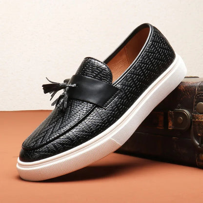 Black men's woven tassel loafers. Classic, comfortable slip-on footwear for a sleek dress shoe or stylish casual look.