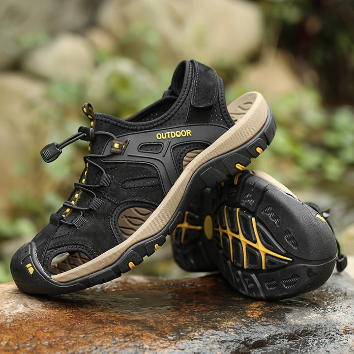 Close-up of men's closed-toe hiking sandals, showing adjustable straps & durable sole for outdoor adventures.