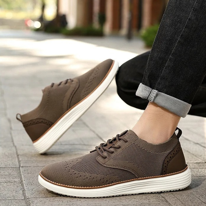 Men's casual formal dress sneakers with intricate wingtip styling and comfort features.