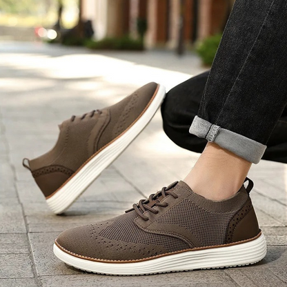 Men's casual formal dress sneakers with intricate wingtip styling and comfort features.