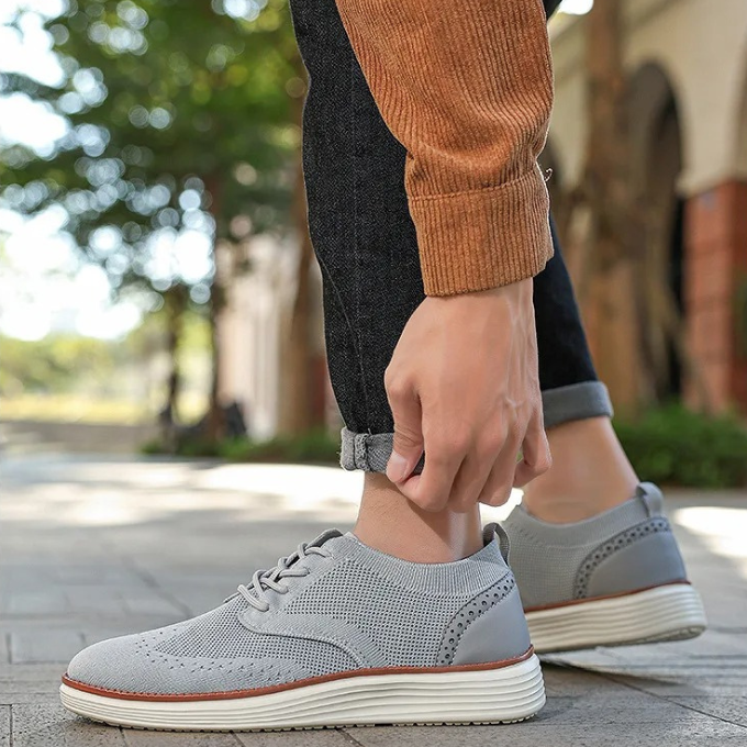 Detailed shot of the durable sole on men's wingtip comfort dress sneakers, ensuring all-day support.