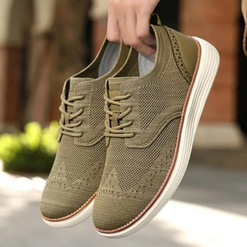 Stylish men's wingtip dress sneakers offering lightweight, breathable all-day comfort.