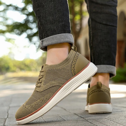 Classic wingtip men's comfort shoes. Lace-up dress sneakers for casual formal fashion.