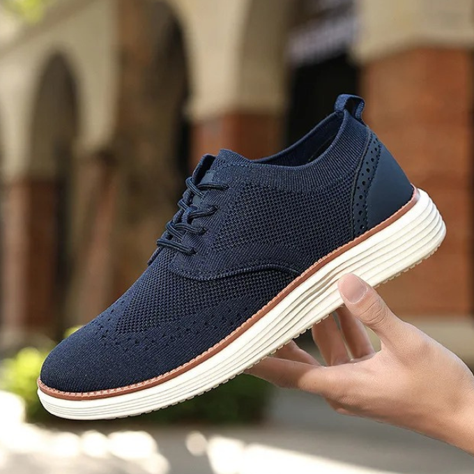 Men's lace-up comfort dress sneakers, wingtip design for modern men's fashion.