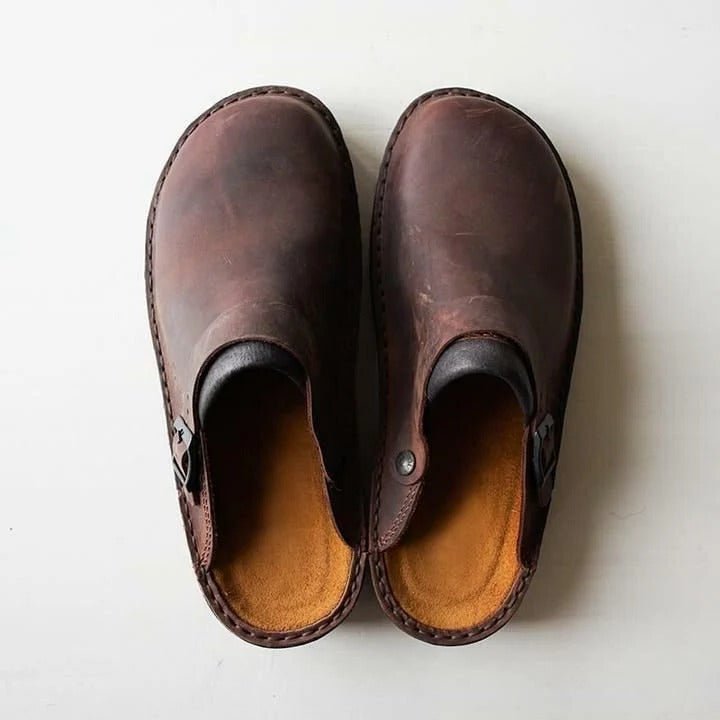 Men's comfortable black slip-on mules with a secure heel strap for casual all-season wear.
