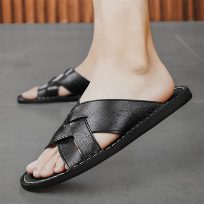 Man wearing comfortable brown cross-strap flat sandals, ideal for summer beach walks.