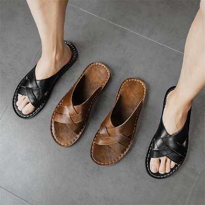 Easy slip-on men's black cross-strap flat sandals, comfortable open-toe summer footwear for casual days.