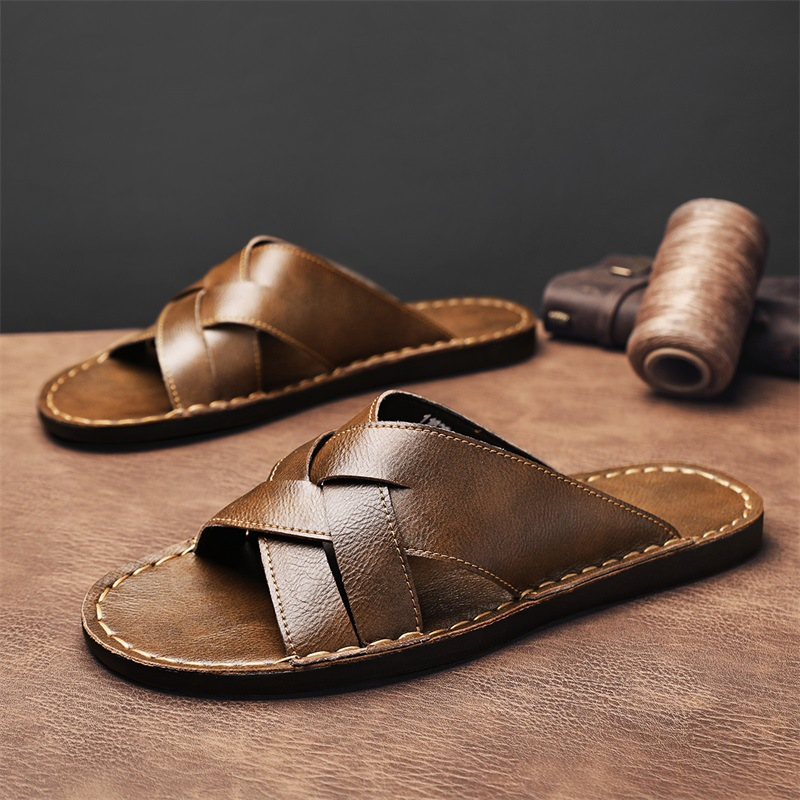 Black men's slip-on cross-strap flat sandals, ideal for beach and summer casual wear.