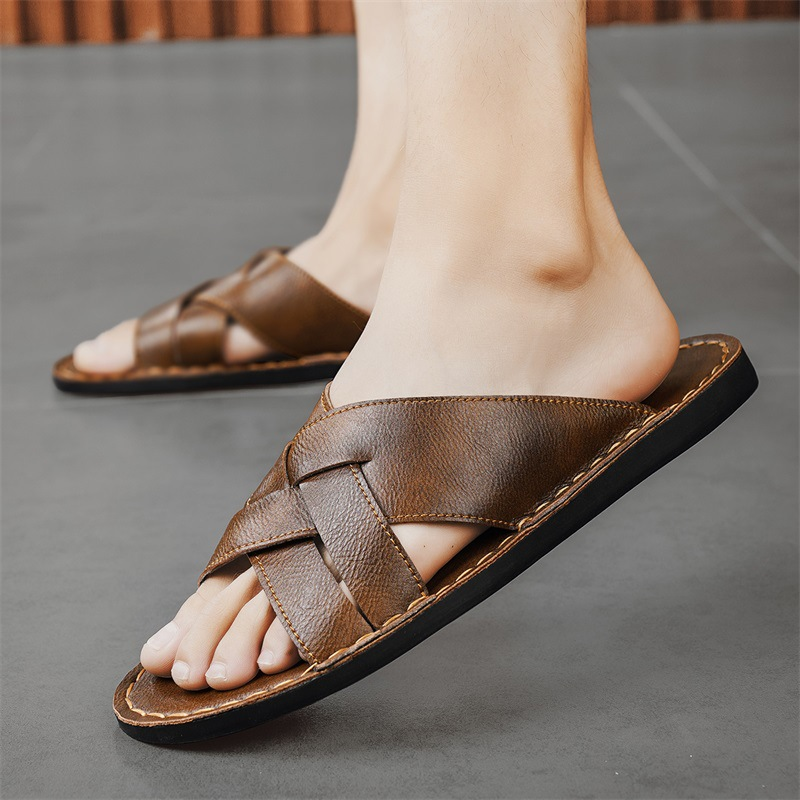 Stylish men's black cross-strap flat sandals, perfect slip-on summer footwear for beach or casual.