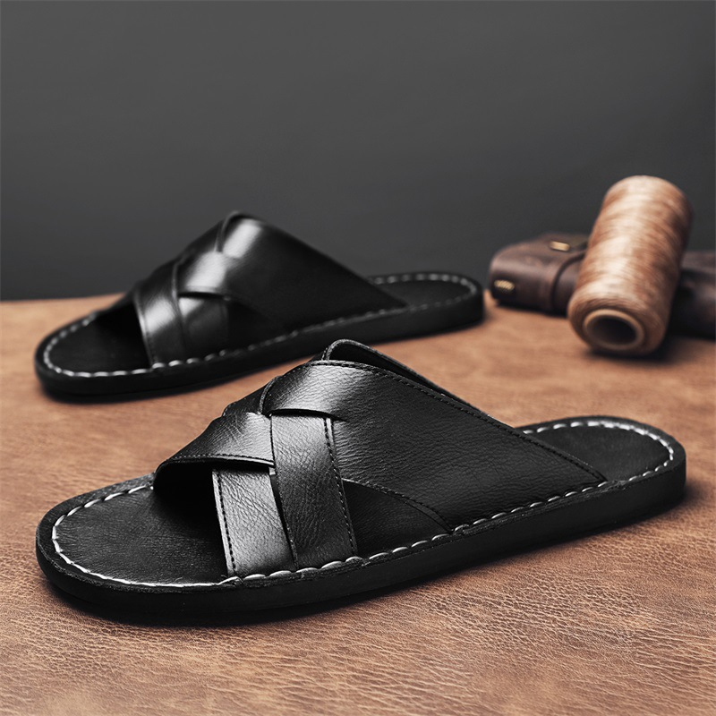Close-up of men's comfortable brown cross-strap flat sandals, showing texture and open-toe design.
