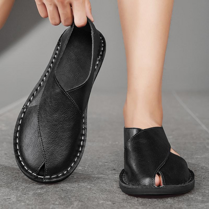 Men's comfortable flat sole sandals with an ergonomic cross-strap design for walking.