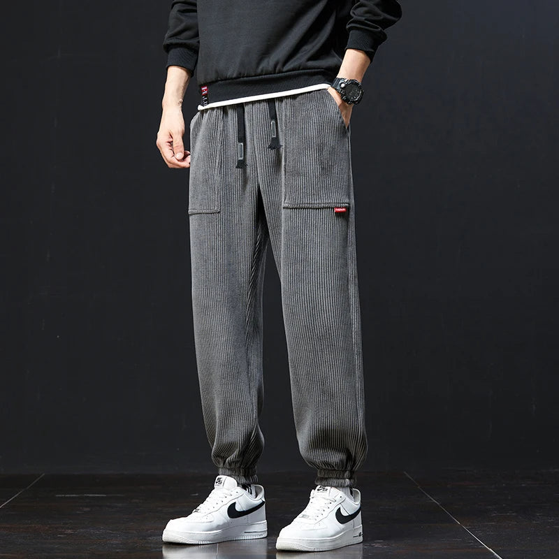Men's comfortable joggers with an elastic waist & adjustable drawstring, offering a relaxed fit for lounge & active wear.