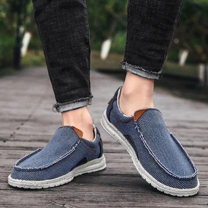 Light gray men's canvas slip-on shoes, offering easy wear and comfort for casual outings with a sturdy sole.