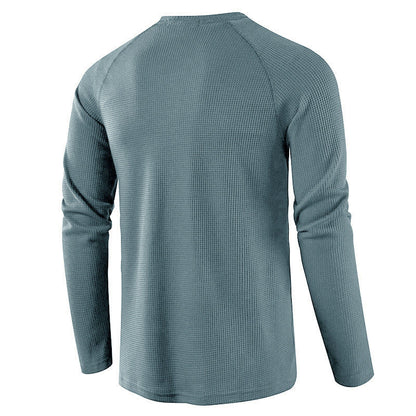 Close-up of knit fabric on men's comfortable henley shirt, showcasing quality.