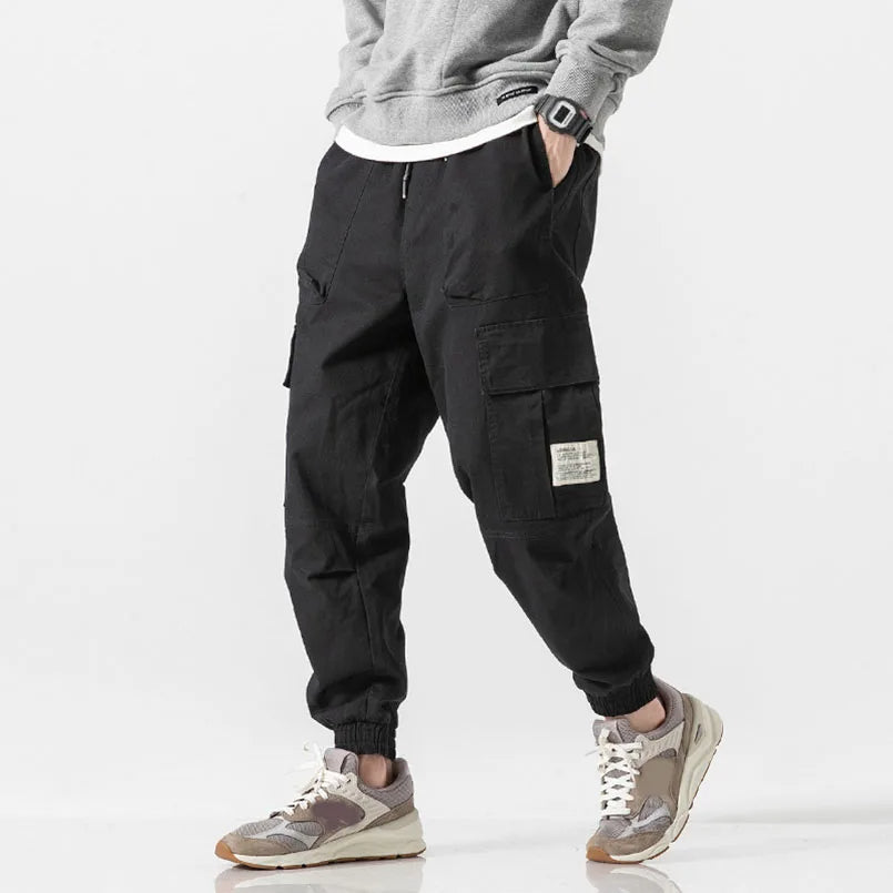 Man wearing comfortable tapered joggers, demonstrating the casual fit and soft cotton blend for active or lounge use.