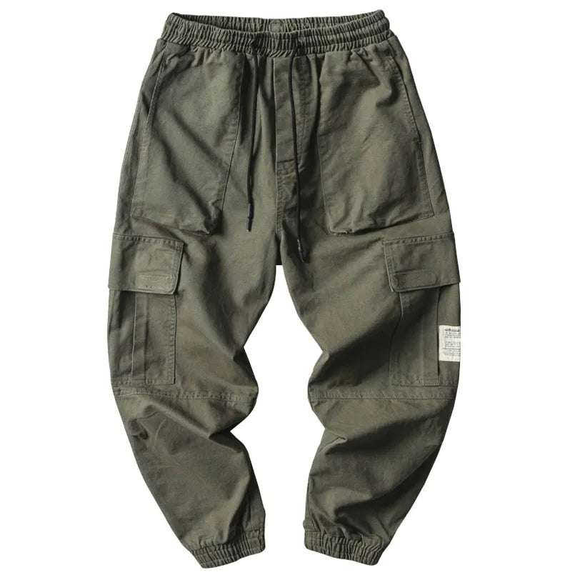 Close-up of men's tapered joggers showing drawstring waist and ribbed cuffs, highlighting the comfortable cotton blend.