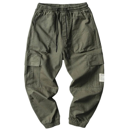 Close-up of men's tapered joggers showing drawstring waist and ribbed cuffs, highlighting the comfortable cotton blend.