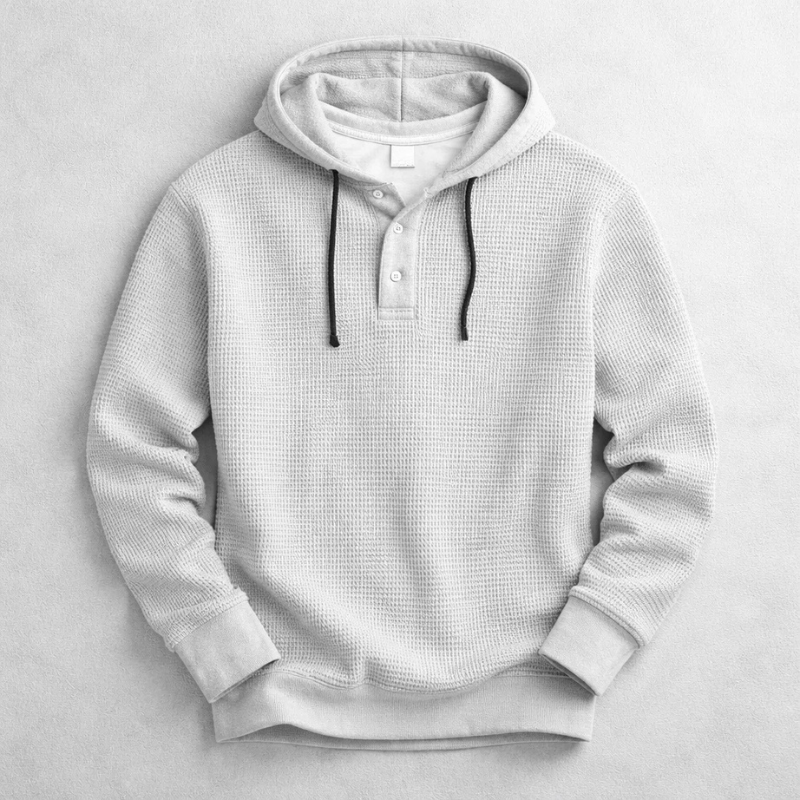 Close-up of men's cozy waffle knit pullover hoodie fabric, highlighting texture for warmth and comfort.