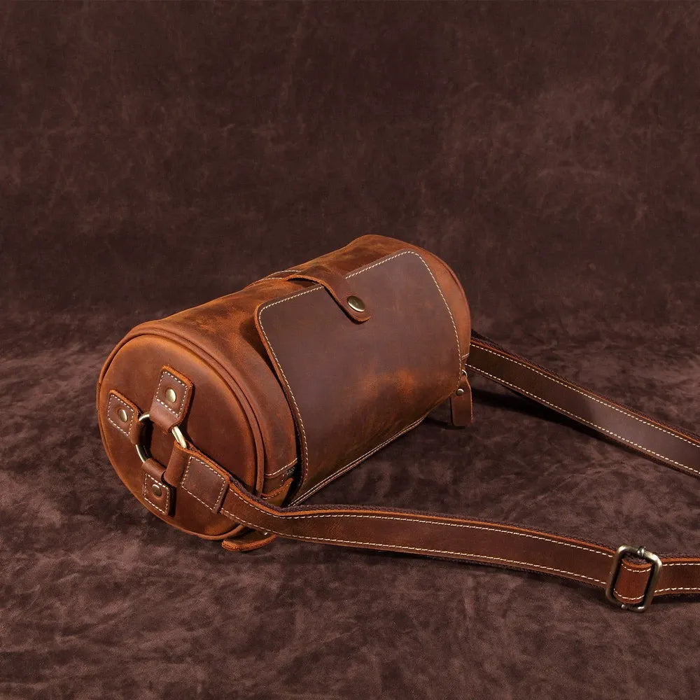 Close-up of the rich texture on the Cooper men's genuine leather messenger bag, coffee color.