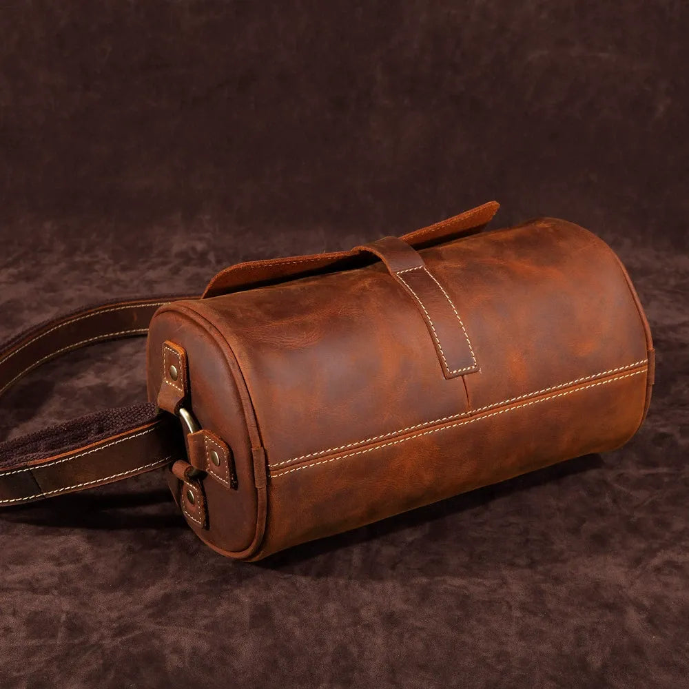 Coffee brown genuine leather messenger bag, Men's Cooper, on a desk, ready for office work.