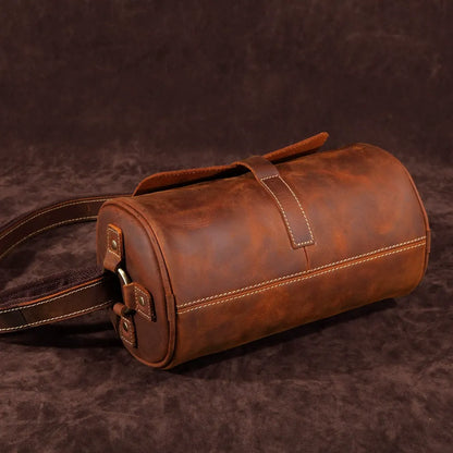 Coffee brown genuine leather messenger bag, Men's Cooper, on a desk, ready for office work.