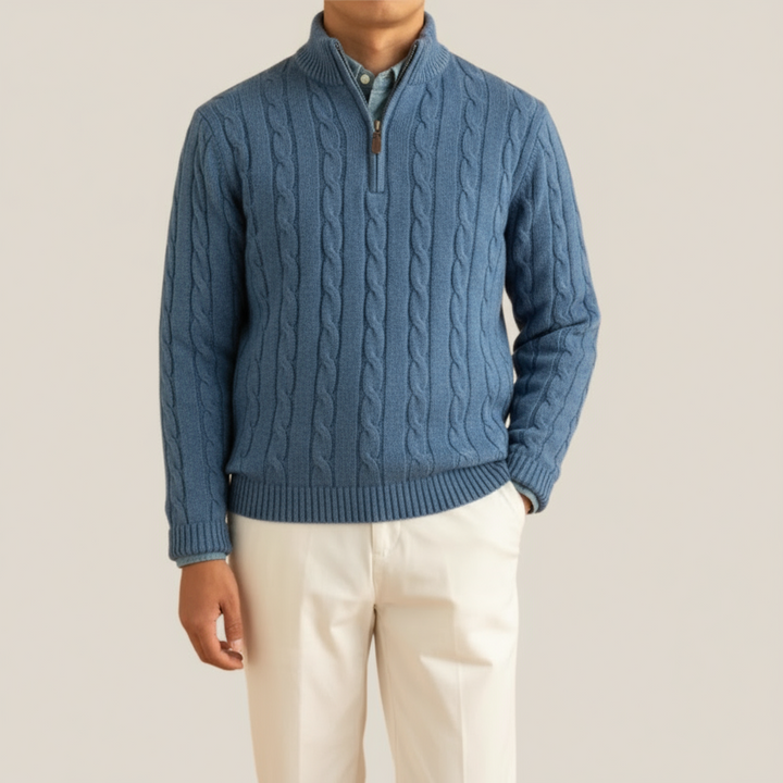 Detail shot of a men's cable knit half-zip pullover, highlighting the rich texture and cozy feel.