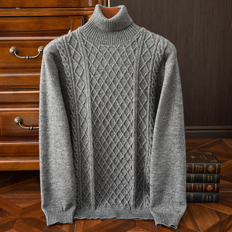 Close-up of the intricate diamond cable knit pattern on a men's warm turtleneck sweater. Cozy fall fashion.