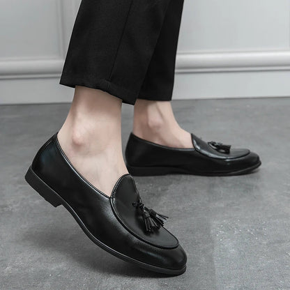 Elegant men's crescent-toe tassel loafers, slip-on style, ideal for formal and semi-formal occasions.