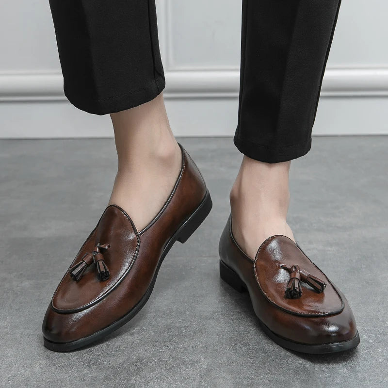 Stylish men's tassel loafers paired with a suit, showcasing versatile formal and casual footwear.