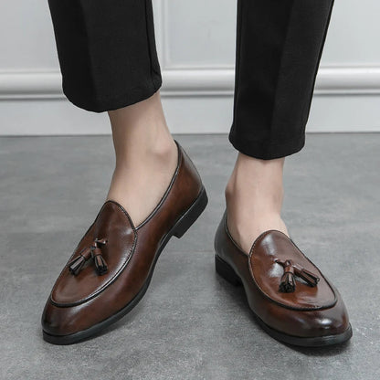 Stylish men's tassel loafers paired with a suit, showcasing versatile formal and casual footwear.