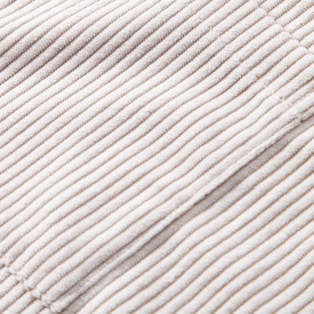 Close-up of a men's short-sleeve Cuban collar shirt, highlighting the soft texture of the corduroy fabric.