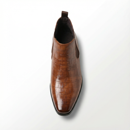 Men's ankle-high leather Chelsea boots in dark brown, a stylish & comfortable choice for urban explorers.