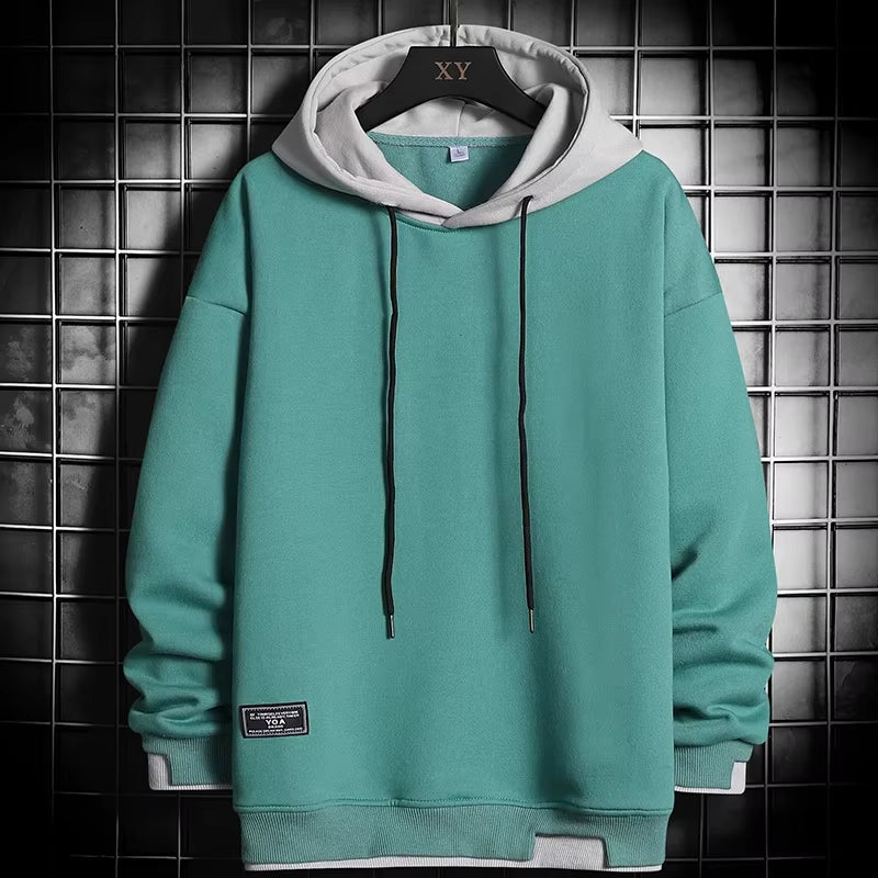 Men's dual-tone layered hem hoodie, modern casual wear for comfortable streetwear style.