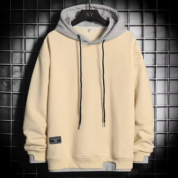 Comfortable men's pullover hoodie, dual-tone design with a stylish layered hem, versatile fashion.