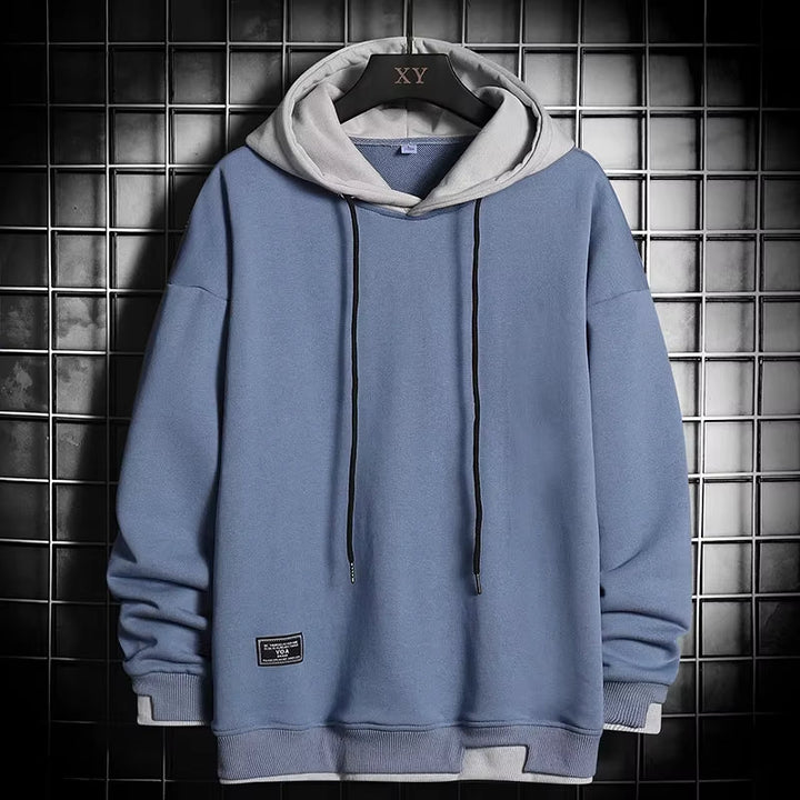 Men's dual-tone hoodie featuring a stylish layered hem, offering modern comfort and a unique casual look.