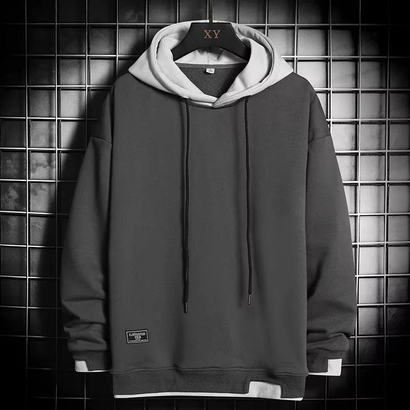 Fashionable men's dual-tone hoodie, layered hem design for ultimate comfort and modern casual apparel.