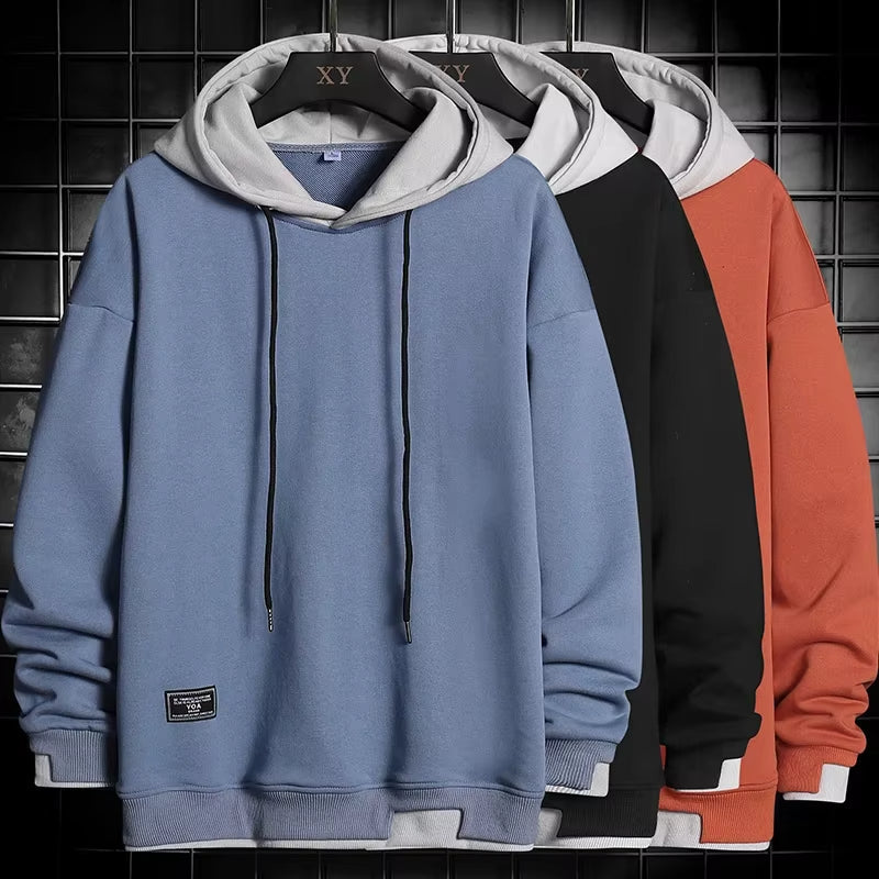 Versatile men's dual-tone layered hem hoodie, combining modern comfort with sleek streetwear fashion.