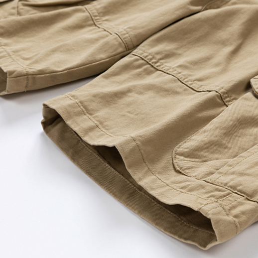 Man sitting comfortably in versatile men's cargo shorts, ideal for relaxed travel & everyday activities.