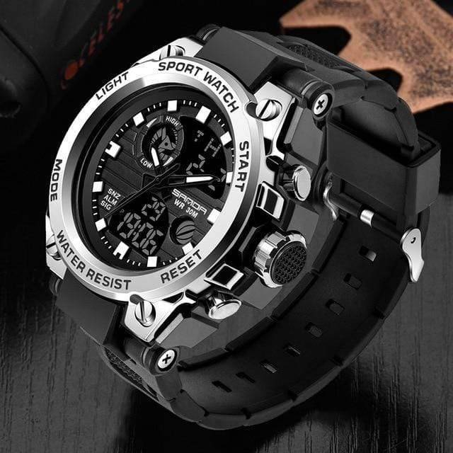 Men's outdoor sport watch laying on rough terrain, highlighting its durability and adventure readiness