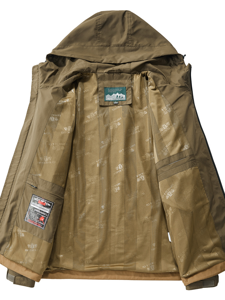Man wearing a durable tactical jacket on an outdoor adventure. All-weather utility outerwear with multi-pocket features.