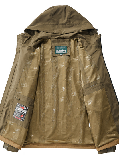 Man wearing a durable tactical jacket on an outdoor adventure. All-weather utility outerwear with multi-pocket features.