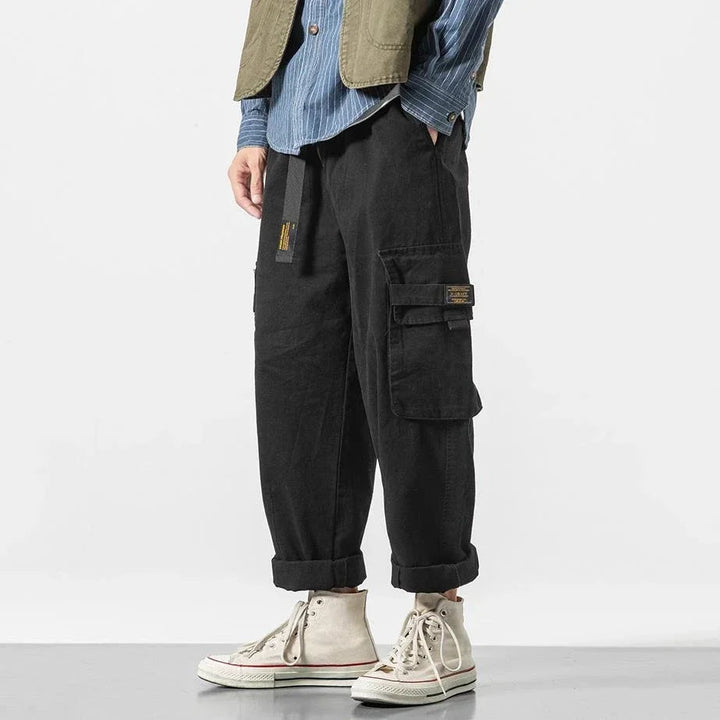 Green men's durable utility cargo pants, comfortable & stylish streetwear apparel.
