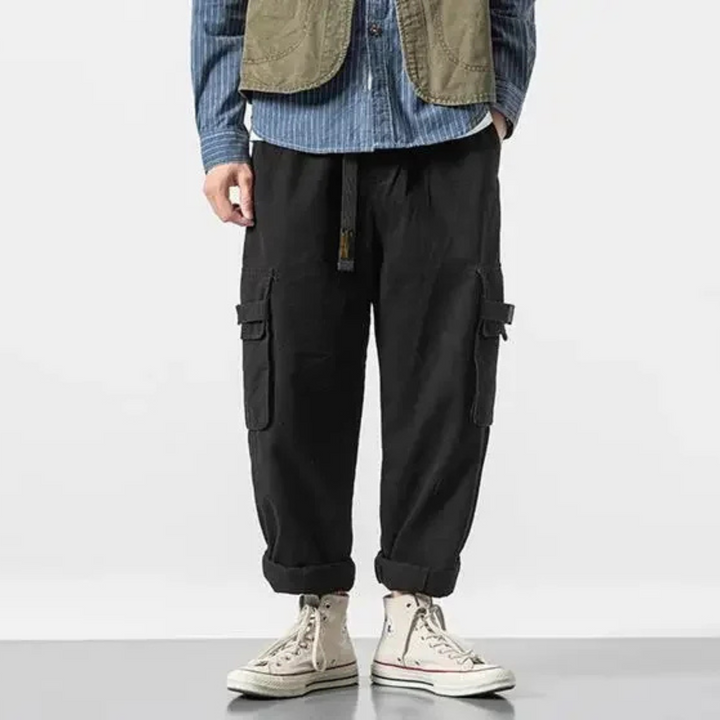 Black men's durable utility cargo pants, comfortable & versatile for urban fashion.
