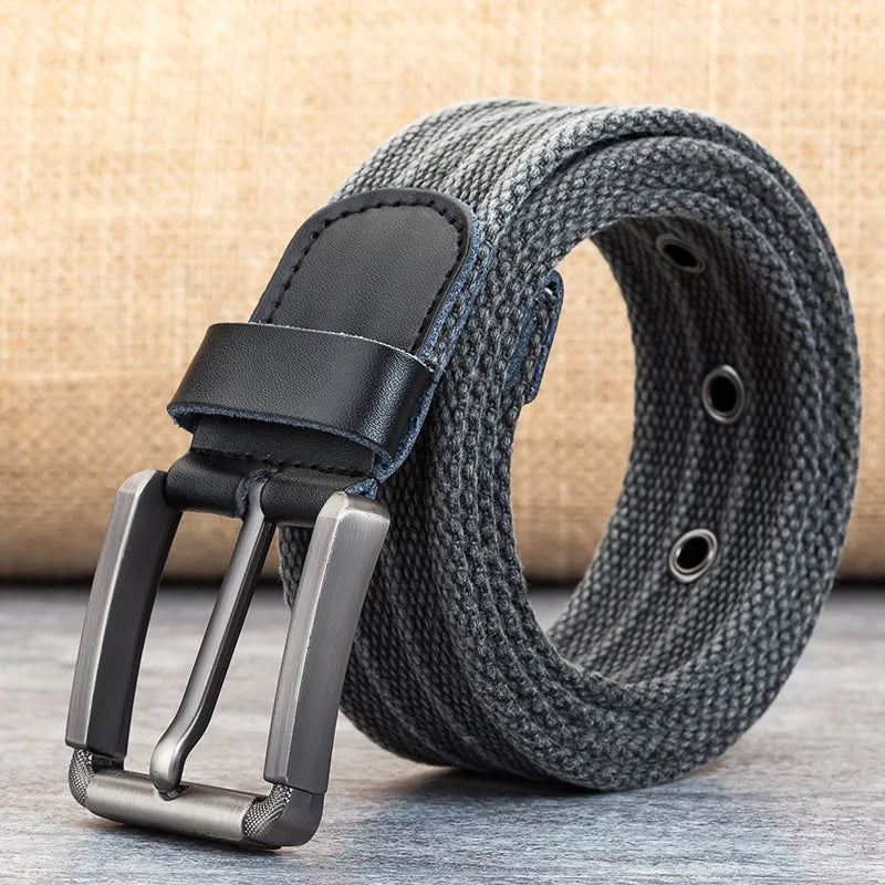 Close-up of men's woven belt featuring intricate texture and high-quality brown leather buckle & tip.
