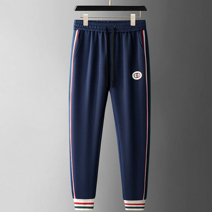Dynamic men's sportswear ensemble. Royal Navy full-zip tracksuit, ideal for workouts or comfortable loungewear.