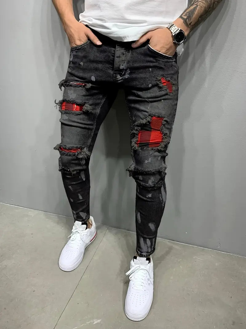 Men's edgy distressed denim pants with a modern tapered fit, perfect for streetwear style.